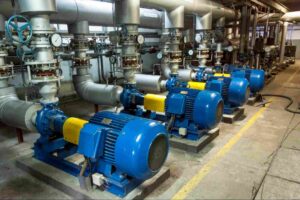 Industrial chemical injection pumps and process piping used with H₂S scavengers in an oil and gas treatment facility.
